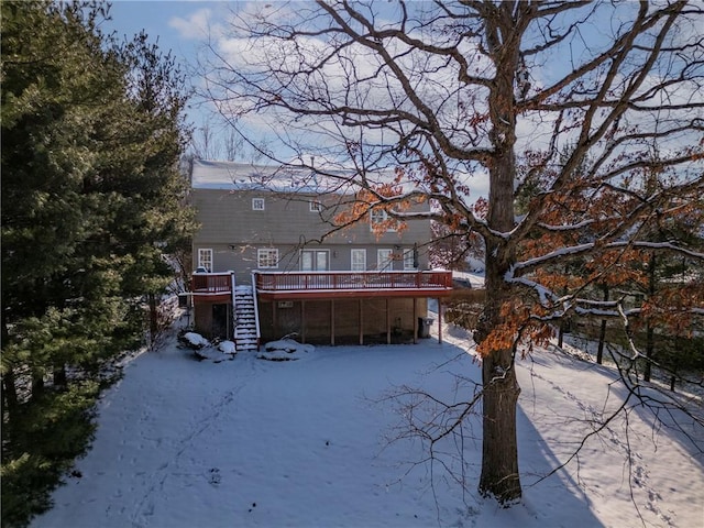 yard covered in snow with a deck