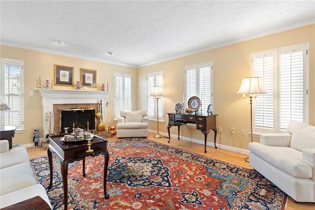 living room featuring a wealth of natural light, ornamental molding, and a fireplace