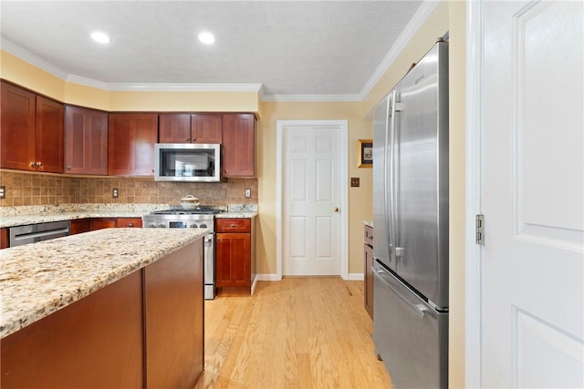 kitchen featuring backsplash, light wood-type flooring, light stone counters, ornamental molding, and stainless steel appliances