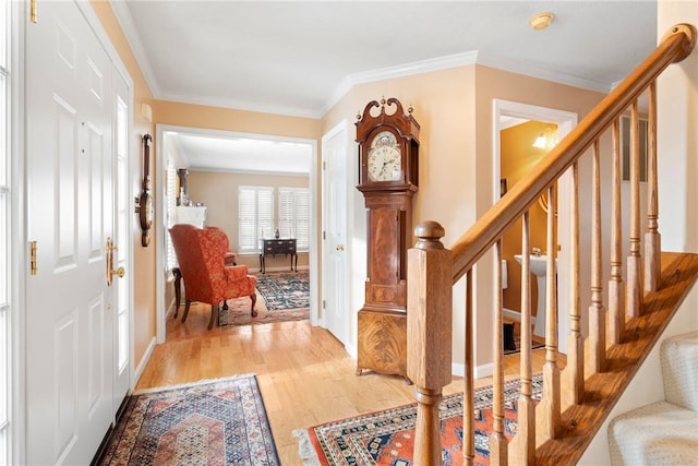 entryway with wood-type flooring and ornamental molding