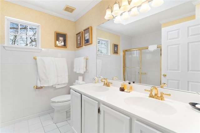 bathroom featuring tile patterned floors, a shower with shower door, tile walls, and vanity