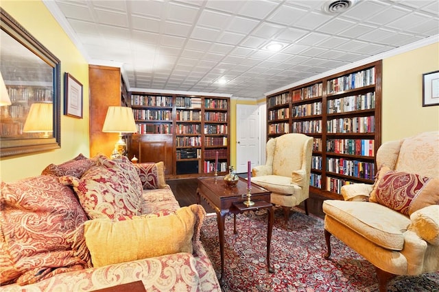 living room featuring crown molding and built in features