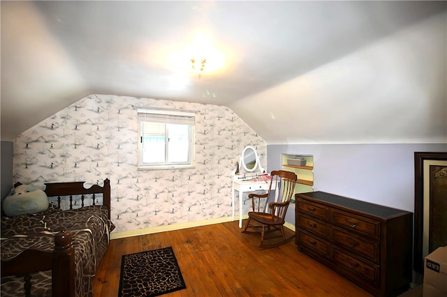 bedroom with dark wood-type flooring and lofted ceiling