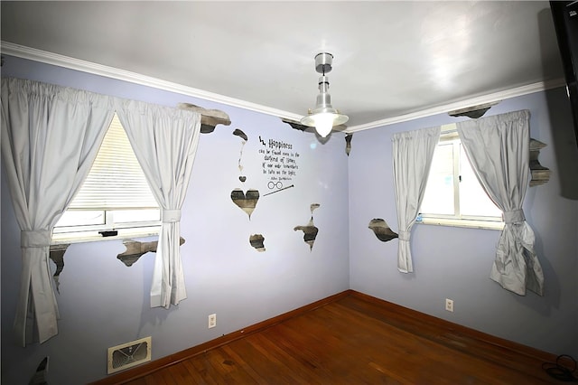 spare room with hardwood / wood-style flooring and crown molding