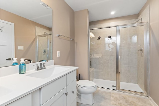 bathroom featuring vanity, walk in shower, tile patterned floors, and toilet