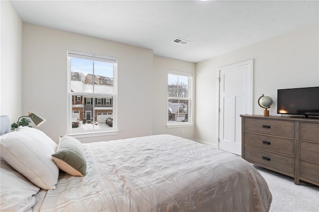 carpeted bedroom featuring multiple windows