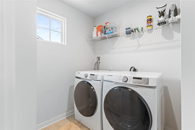 clothes washing area featuring washer and clothes dryer