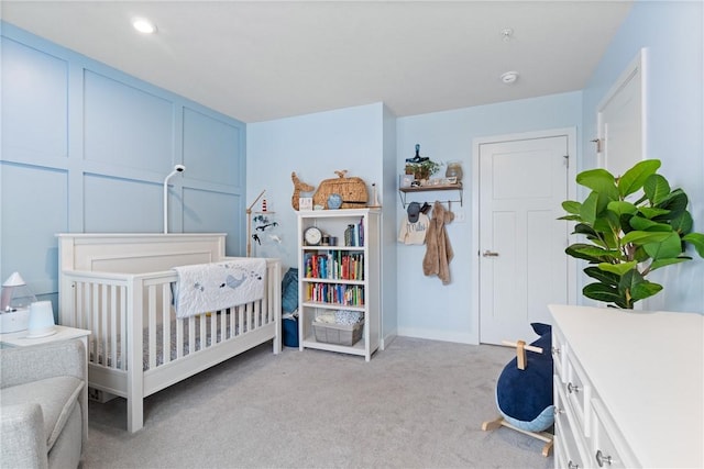 bedroom featuring light colored carpet and a crib