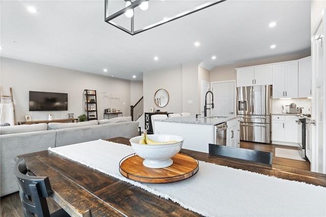 dining room featuring sink and dark hardwood / wood-style floors