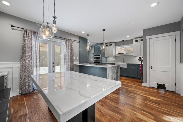 kitchen with a center island, pendant lighting, and dark wood-type flooring