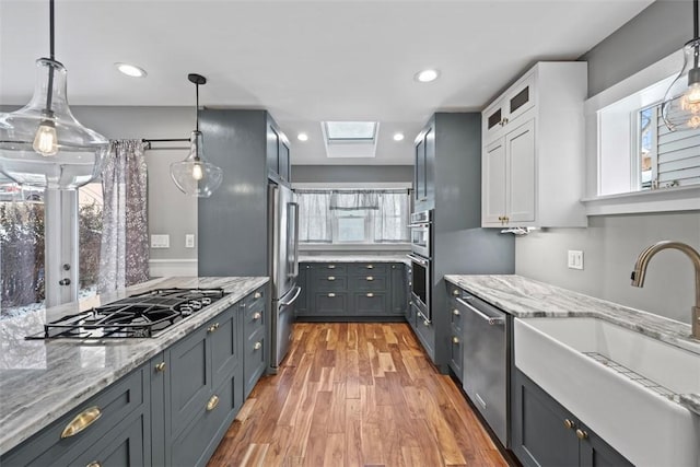 kitchen featuring sink, white cabinets, a healthy amount of sunlight, and appliances with stainless steel finishes