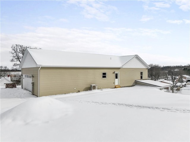 snow covered property featuring a garage