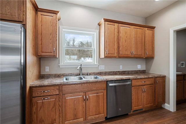 kitchen featuring sink, stainless steel appliances, and dark hardwood / wood-style flooring