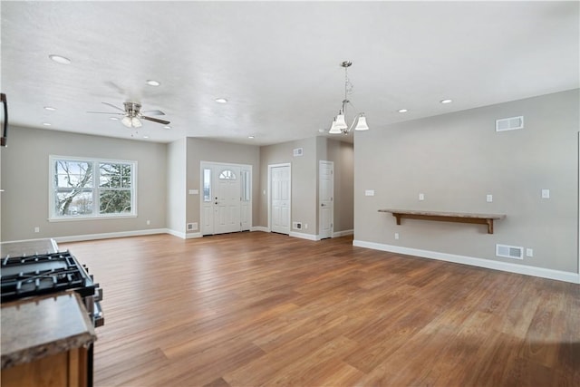 interior space with wood-type flooring and ceiling fan