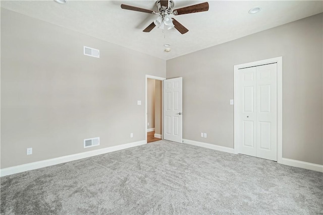 unfurnished bedroom featuring ceiling fan, a closet, and carpet floors