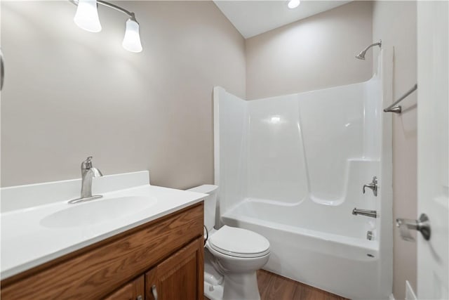 full bathroom with vanity, toilet, tub / shower combination, and hardwood / wood-style flooring