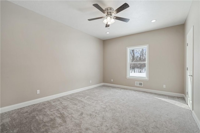 carpeted empty room featuring ceiling fan