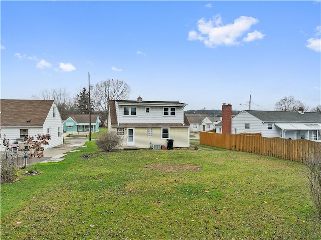 rear view of property featuring a yard