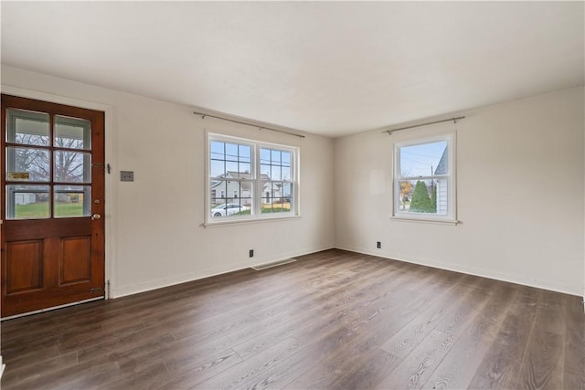 entrance foyer with dark hardwood / wood-style floors