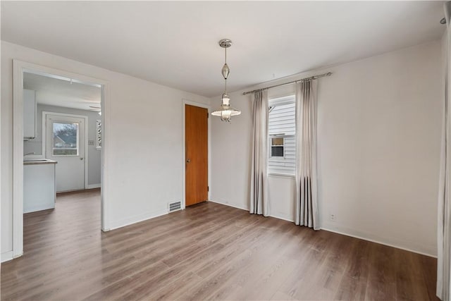 unfurnished dining area featuring hardwood / wood-style flooring