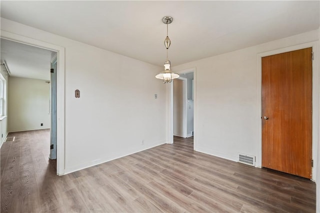 spare room featuring wood-type flooring