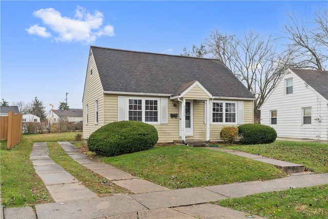 bungalow-style home featuring a front yard