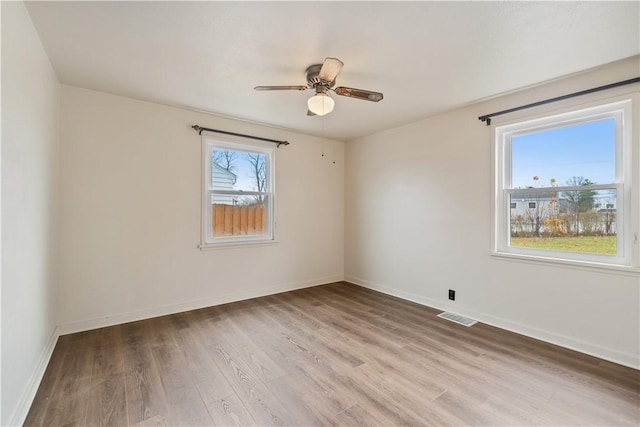 spare room with light wood-type flooring and ceiling fan