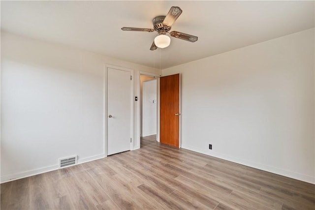 unfurnished room with ceiling fan and light hardwood / wood-style floors