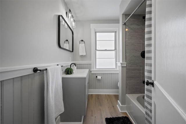 full bathroom with vanity, toilet, hardwood / wood-style floors, and tiled shower / bath combo