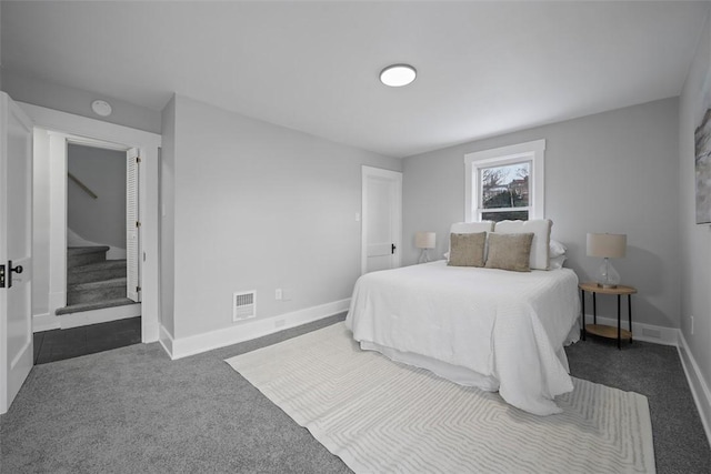 bedroom with dark colored carpet