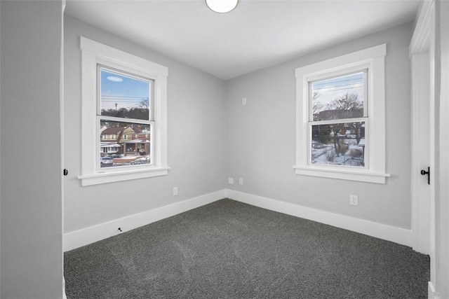 carpeted spare room featuring a wealth of natural light