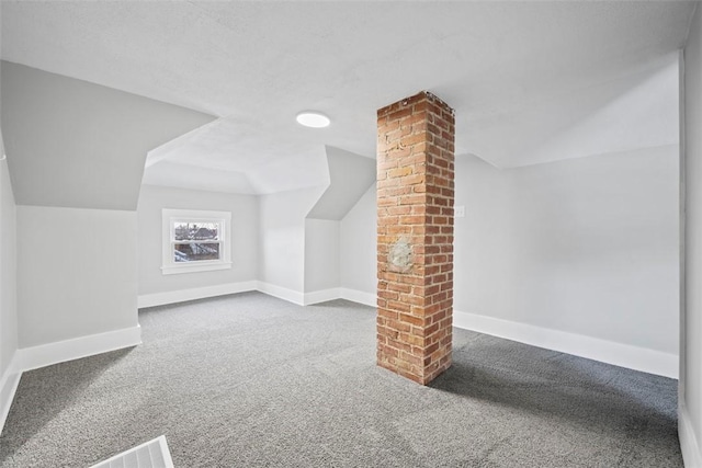 additional living space featuring vaulted ceiling and carpet