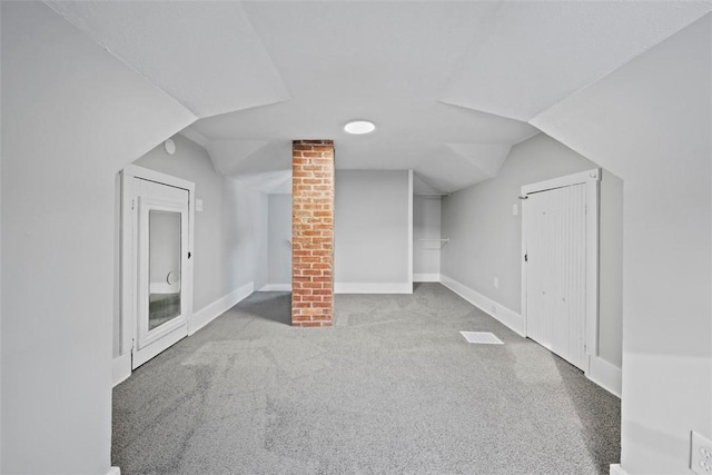 additional living space with vaulted ceiling and carpet