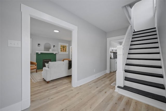 stairs with hardwood / wood-style floors