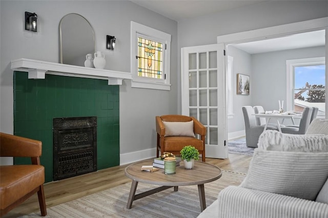 sitting room featuring a fireplace and light hardwood / wood-style flooring