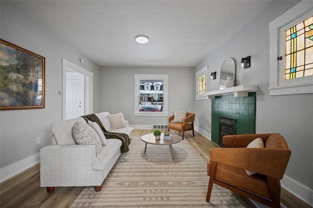 living room featuring hardwood / wood-style flooring and a fireplace