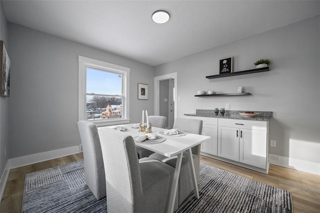 dining space with hardwood / wood-style flooring