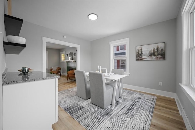 dining space featuring a healthy amount of sunlight and light hardwood / wood-style flooring