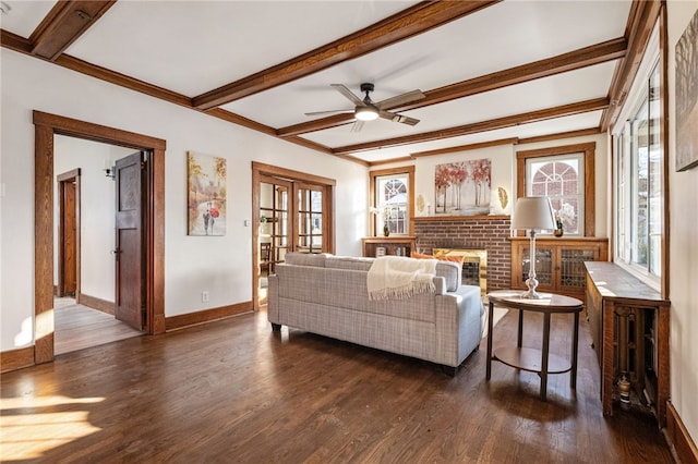 living room featuring dark wood-type flooring, french doors, ceiling fan, a brick fireplace, and beam ceiling