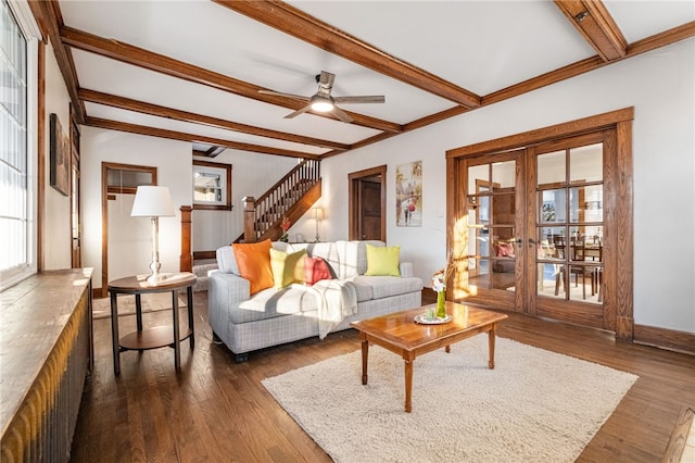 living room featuring dark wood-type flooring, beamed ceiling, ceiling fan, and french doors