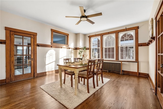 dining space featuring ceiling fan, dark hardwood / wood-style floors, and radiator