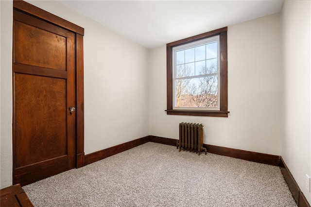 empty room with carpet and radiator