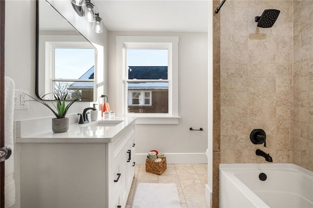 bathroom with tile patterned floors, vanity, and tiled shower / bath