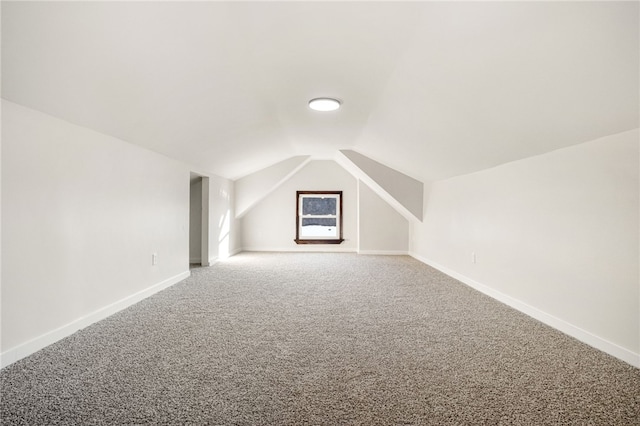 bonus room featuring lofted ceiling and carpet flooring