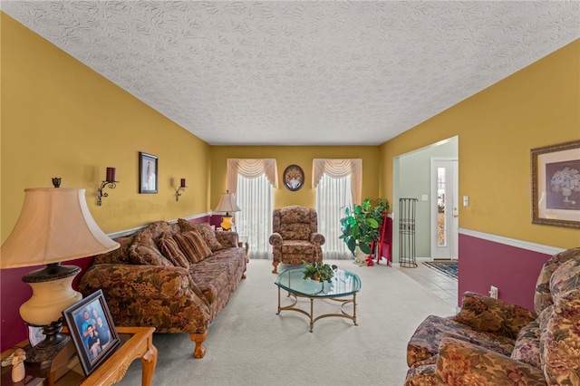 carpeted living room featuring a textured ceiling