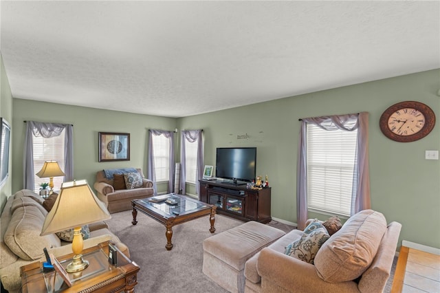 living room featuring a textured ceiling and light tile patterned floors