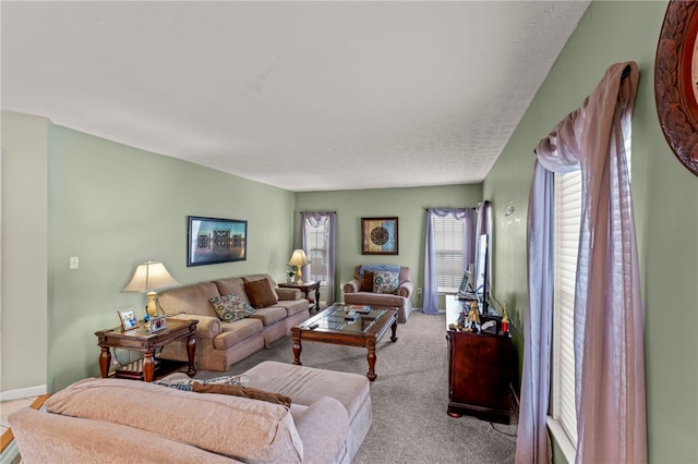 living room featuring a textured ceiling and light colored carpet