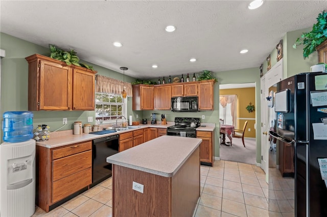 kitchen with hanging light fixtures, sink, light tile patterned flooring, a kitchen island, and black appliances