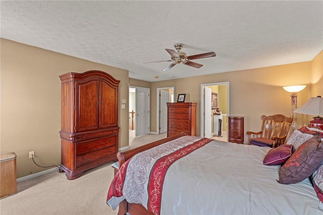 carpeted bedroom featuring ceiling fan and a textured ceiling