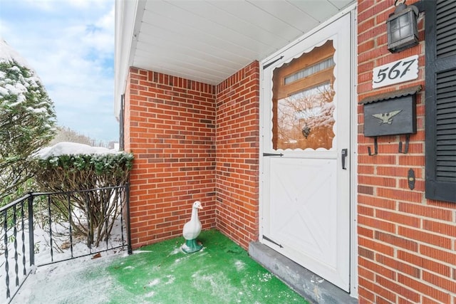 view of snow covered property entrance